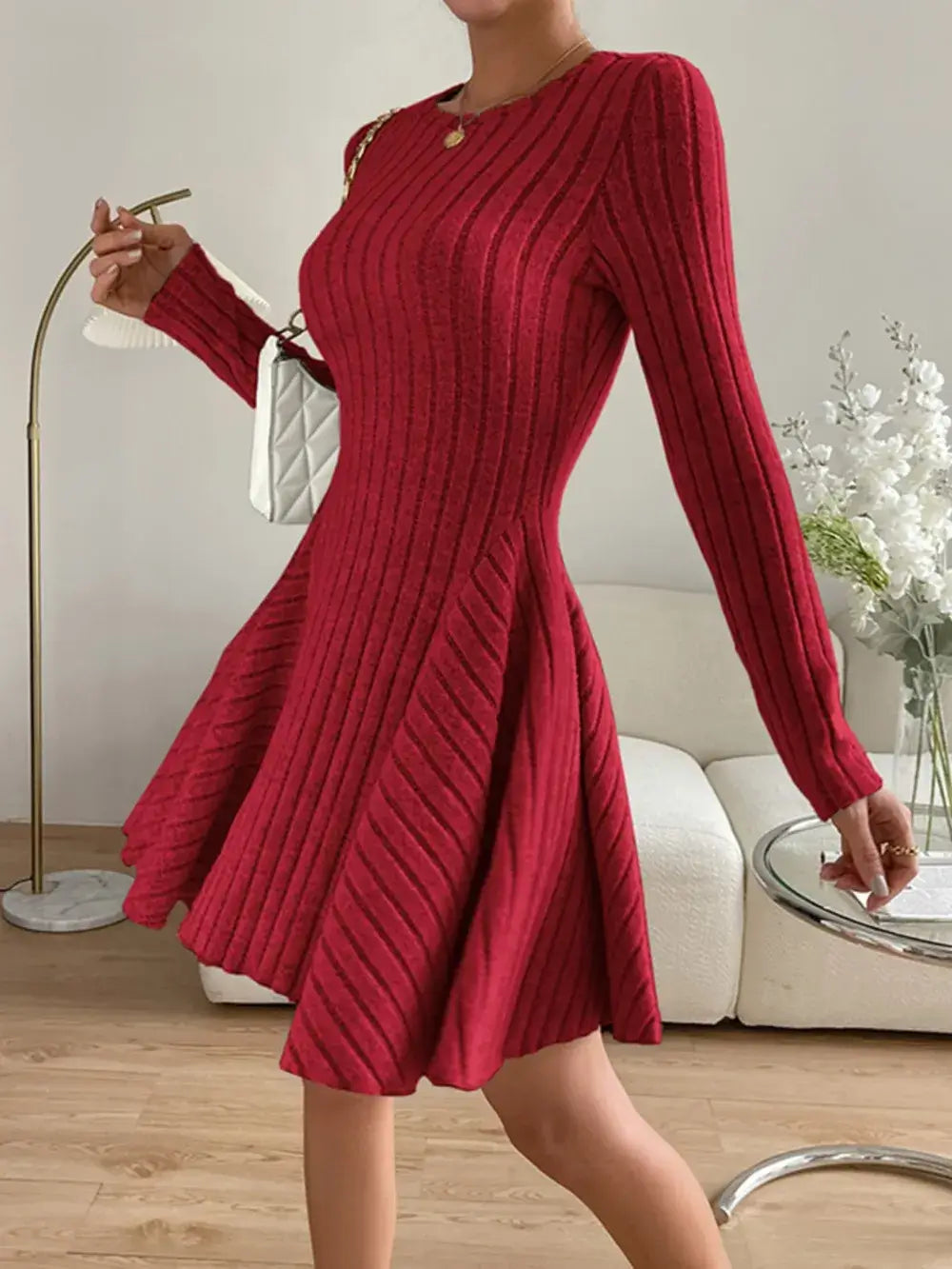 Woman wearing a red Ribbed Round Neck Long Sleeve Dress, showcasing its slightly stretchy material and elegant fit.