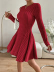 Woman wearing a red Ribbed Round Neck Long Sleeve Dress, showcasing its slightly stretchy material and elegant fit.