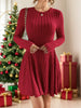 Woman wearing Ribbed Round Neck Long Sleeve Dress in red near Christmas tree and gifts, highlighting festive style.
